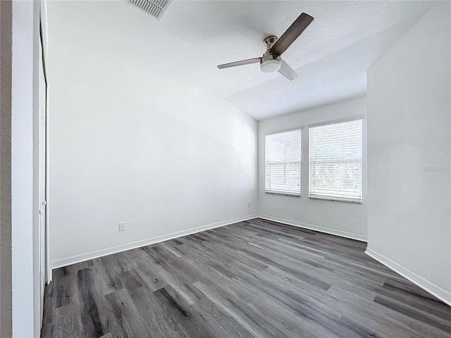 unfurnished room with vaulted ceiling, ceiling fan, a textured ceiling, and dark hardwood / wood-style flooring