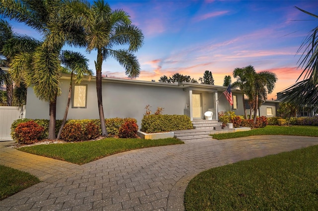 ranch-style house featuring a yard