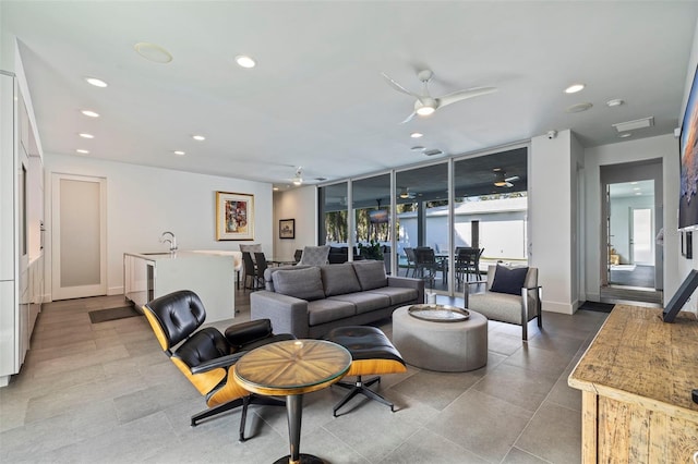 living room with ceiling fan and sink