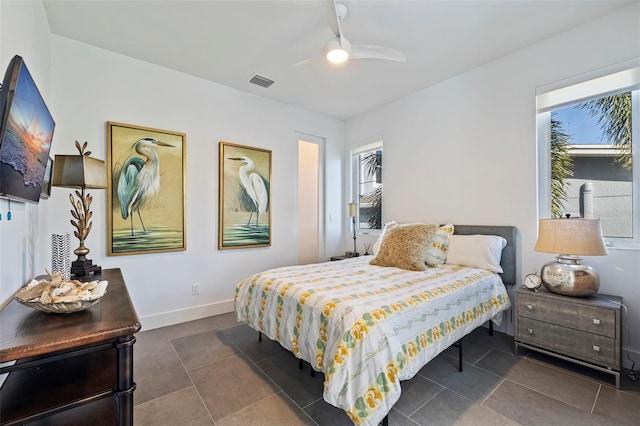 tiled bedroom featuring ceiling fan