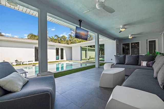 sunroom featuring a swimming pool and ceiling fan