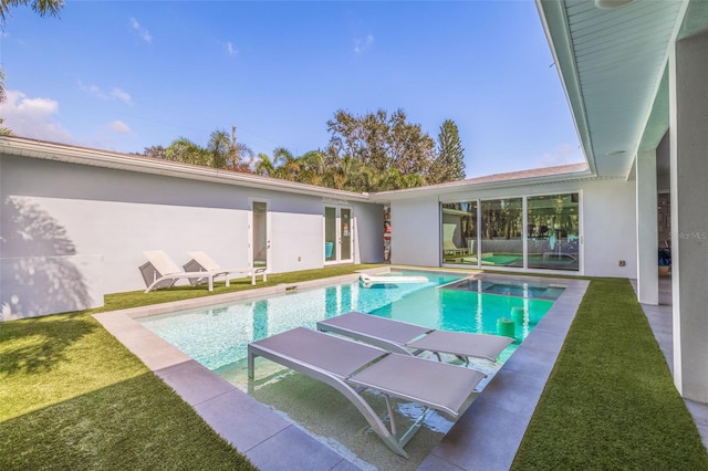 view of swimming pool with a yard and a patio area