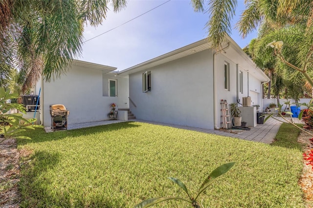 back of house with a lawn