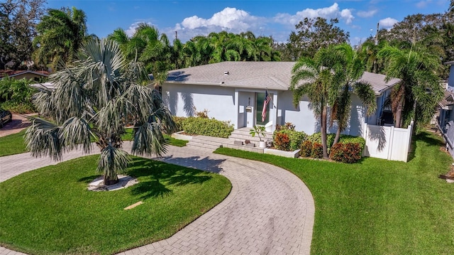 single story home featuring a front lawn