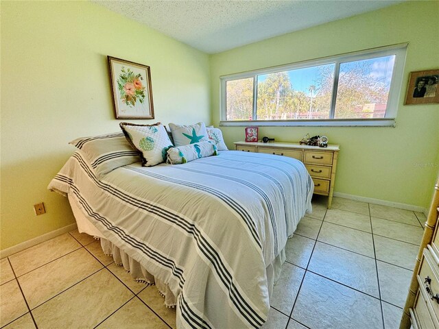 tiled bedroom with a textured ceiling