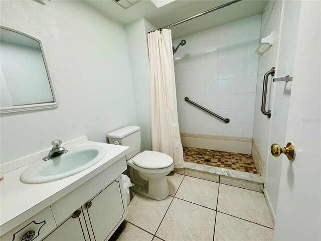 bathroom with vanity, toilet, tile patterned floors, and curtained shower