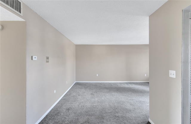 carpeted spare room with a textured ceiling