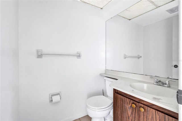 bathroom featuring vanity, toilet, and tile patterned flooring