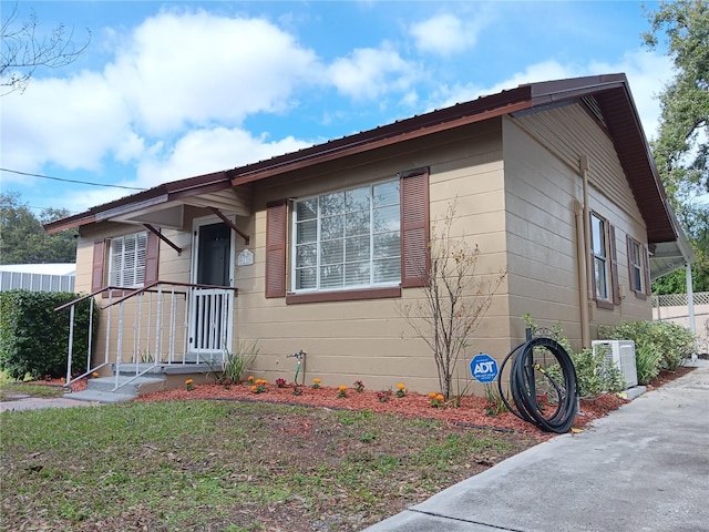 view of side of property featuring central AC unit