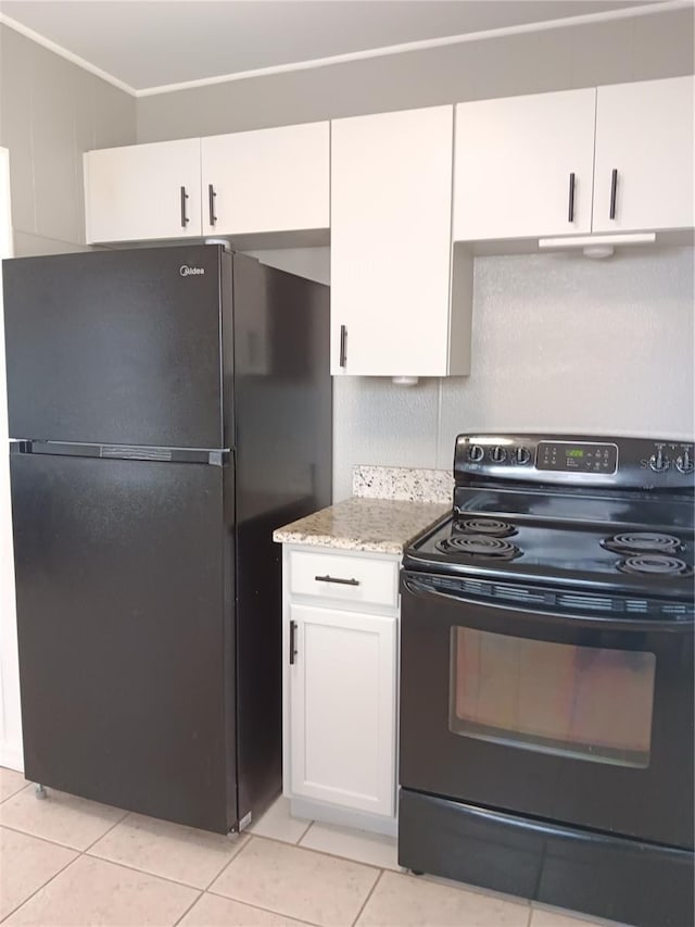 kitchen featuring light stone counters, black appliances, light tile patterned floors, and white cabinets