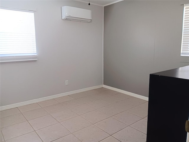 tiled spare room with a wall unit AC