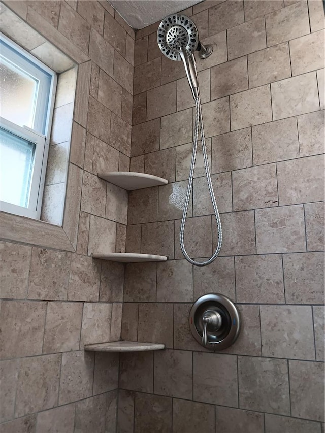 bathroom with tiled shower