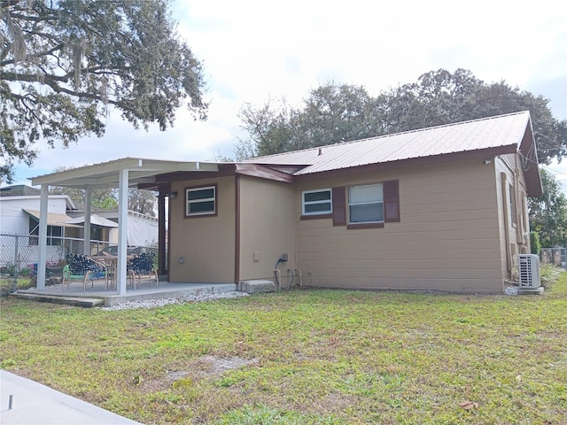 back of house featuring a yard and a patio area