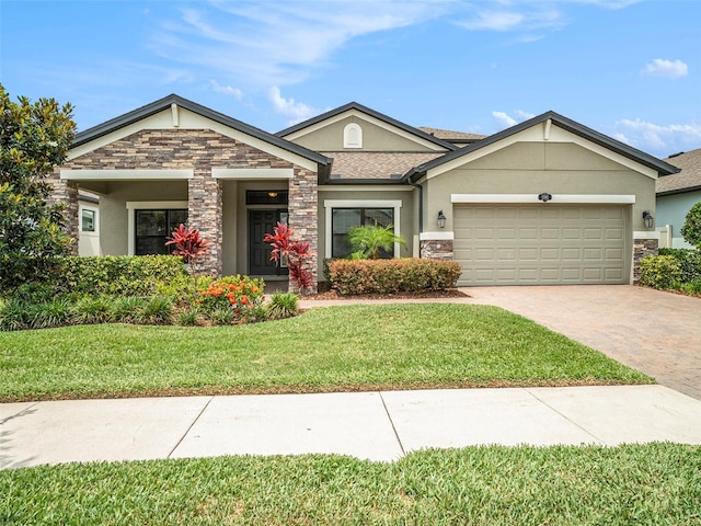 view of front of home featuring a front yard and a garage