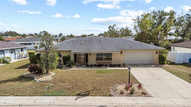 ranch-style home with a garage and a front yard