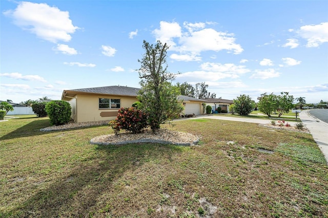 view of front of property featuring a garage and a front lawn