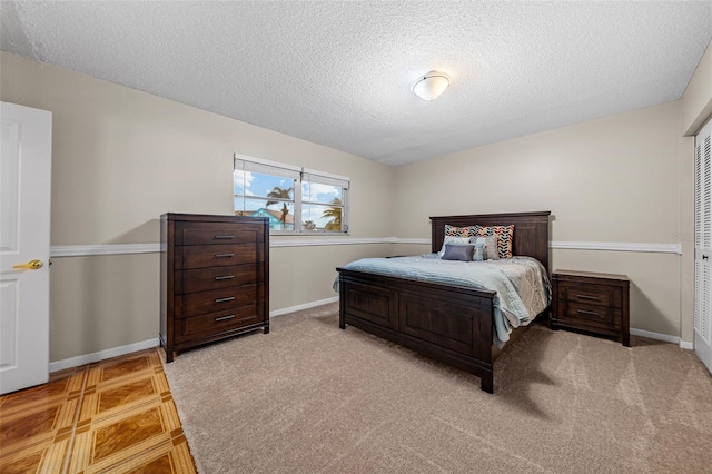 bedroom featuring a textured ceiling and a closet