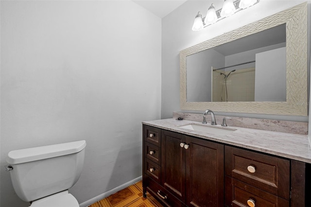 bathroom featuring a shower, tile patterned flooring, vanity, and toilet