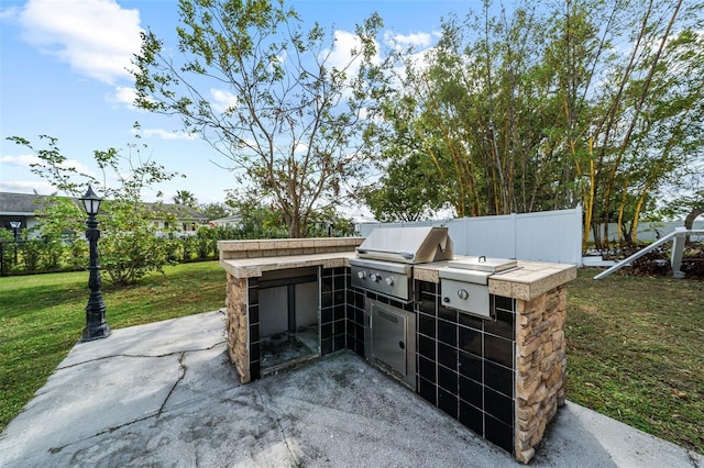 view of patio / terrace with an outdoor kitchen and area for grilling