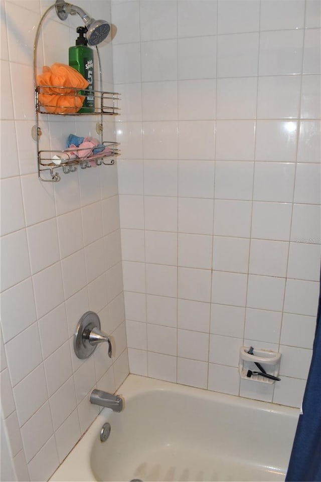 bathroom with shower / tub combo with curtain