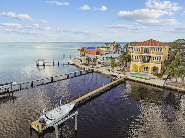 view of dock featuring a water view, a pool, and a balcony