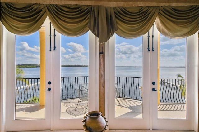 doorway to outside with a water view and french doors