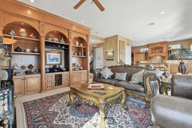 tiled living room featuring ceiling fan and built in features