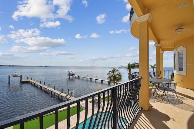 balcony featuring a water view and a dock