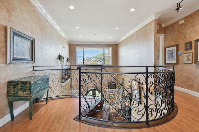 hall with light hardwood / wood-style floors and crown molding