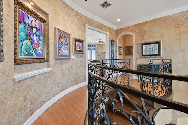 hall with crown molding and hardwood / wood-style flooring