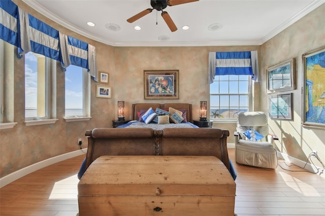 bedroom featuring ceiling fan, ornamental molding, and hardwood / wood-style floors