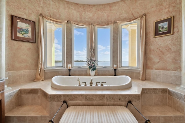 bathroom with a relaxing tiled tub