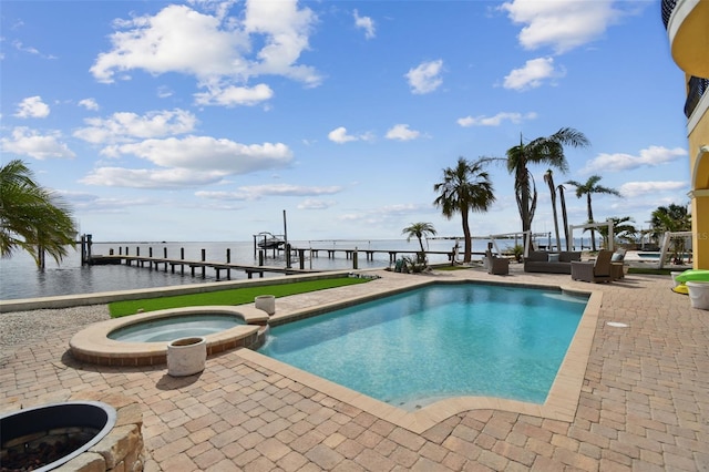 view of swimming pool with a water view, a patio, and an in ground hot tub