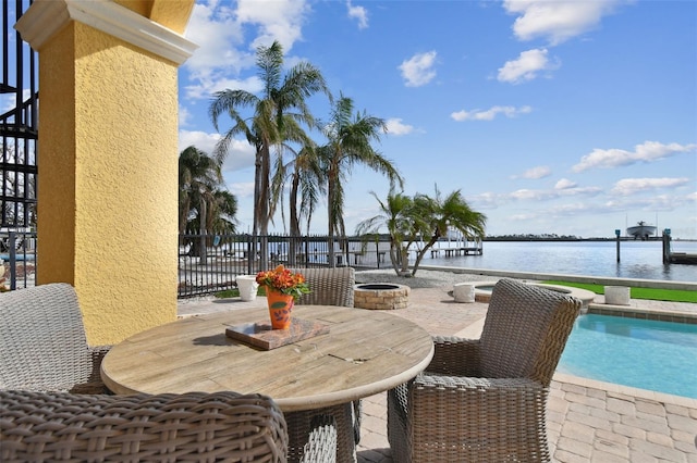 view of patio / terrace featuring an outdoor fire pit and a water view