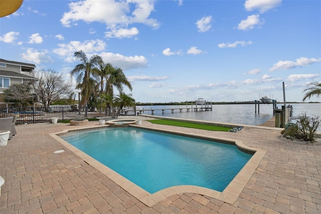 view of pool featuring an in ground hot tub, a boat dock, a water view, and a patio