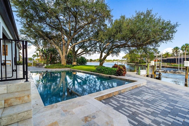 view of swimming pool with a water view and a boat dock