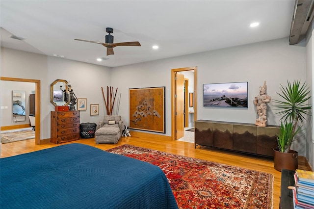 bedroom featuring ceiling fan, wood-type flooring, and ensuite bathroom