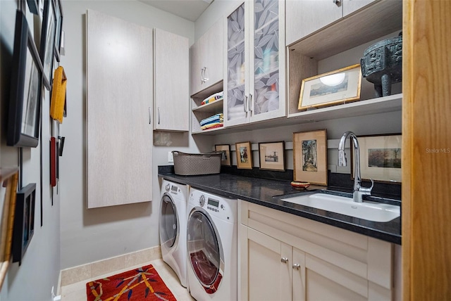 washroom featuring tile patterned flooring, washing machine and dryer, sink, and cabinets