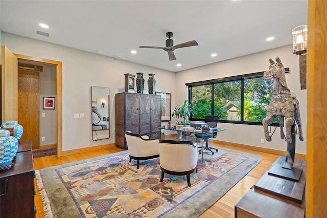 living room featuring ceiling fan and hardwood / wood-style flooring