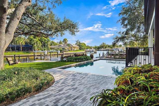 view of pool with a water view and a boat dock