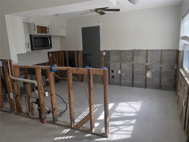 kitchen with white cabinetry and ceiling fan