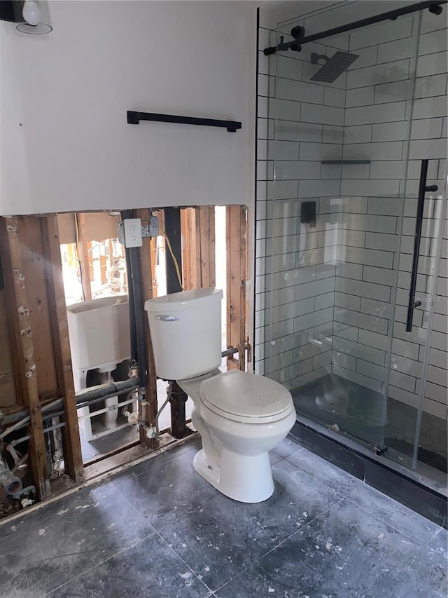 bathroom with toilet and an enclosed shower