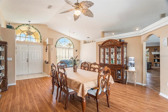 dining room featuring light hardwood / wood-style floors, lofted ceiling, and ceiling fan