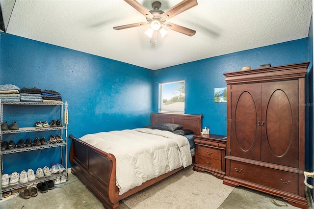 bedroom featuring concrete flooring, a textured ceiling, and ceiling fan