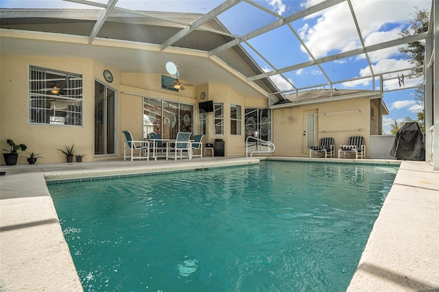 view of swimming pool featuring a lanai, a patio, and ceiling fan