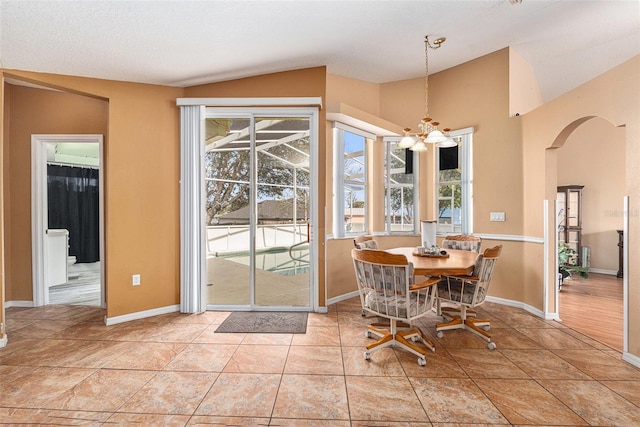 dining room with light tile patterned flooring and a chandelier