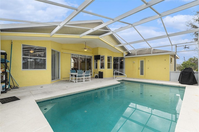 view of swimming pool with ceiling fan, a patio, grilling area, and glass enclosure