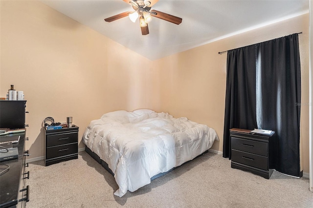 bedroom with ceiling fan, light colored carpet, and lofted ceiling