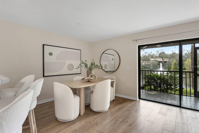 dining space with wood-type flooring