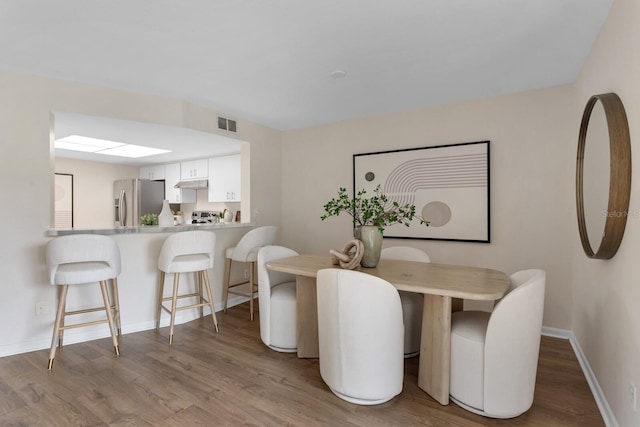 dining area with hardwood / wood-style flooring